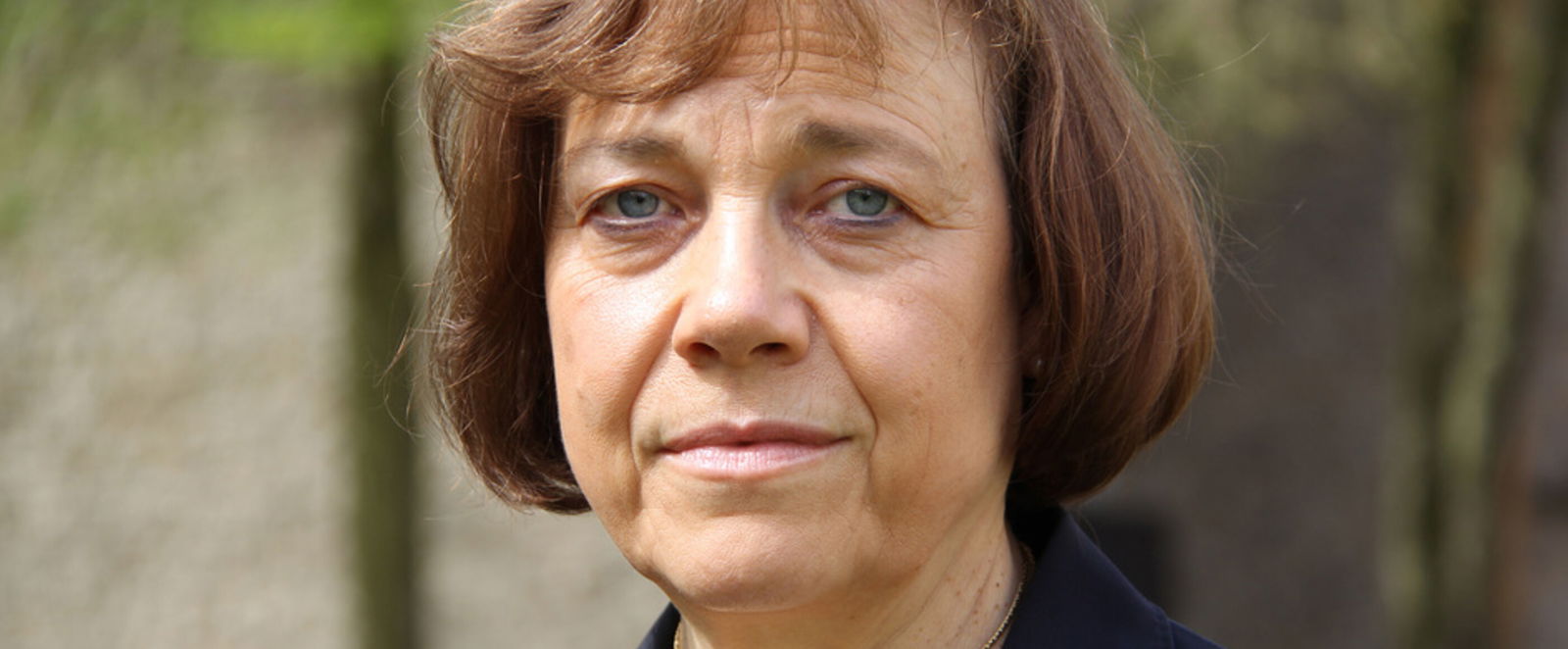 Eine Frau schaut mit ernstem Gesicht in die Kamera.