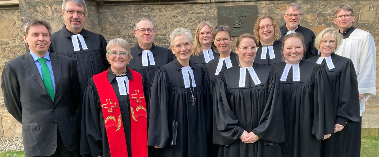 Eine Frau steht vor einer Mauer.