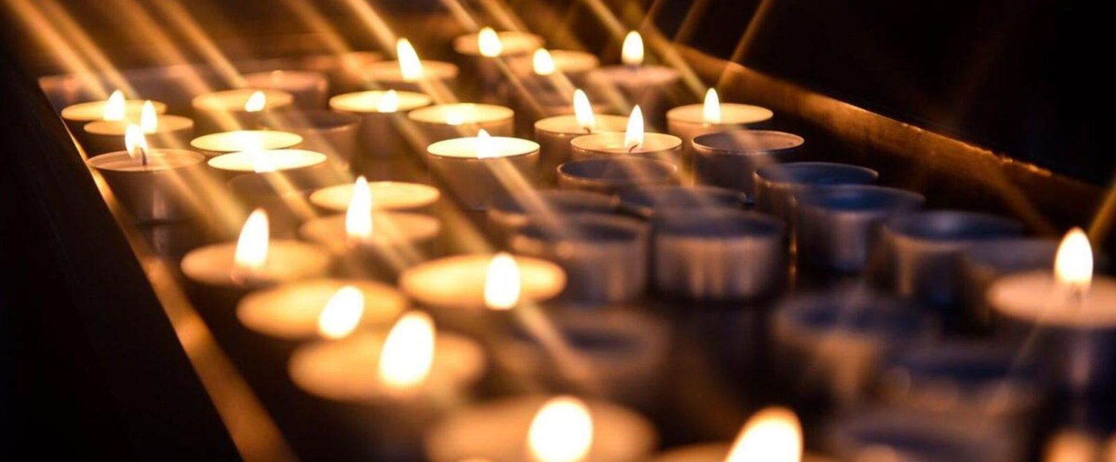 Mehrere Teelichter in einer Kirche