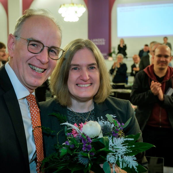 Zwei Personen schauen in die Kamera