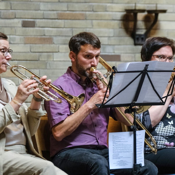 Mehrere Personen spielen Instrumente in einer Kirche
