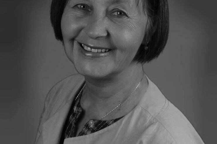 Eine Frau mittleren Alters mit kurzen Haaren in schwarz-weiß.