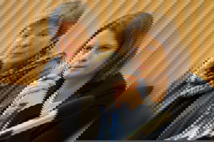 Eine ältere und eine jüngere Frau hören konzentriert zu.