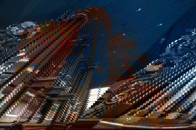 Blick von unten entlang großer, silbern schimmernder Orgelpfeifen mit Gold-Verzierungen.