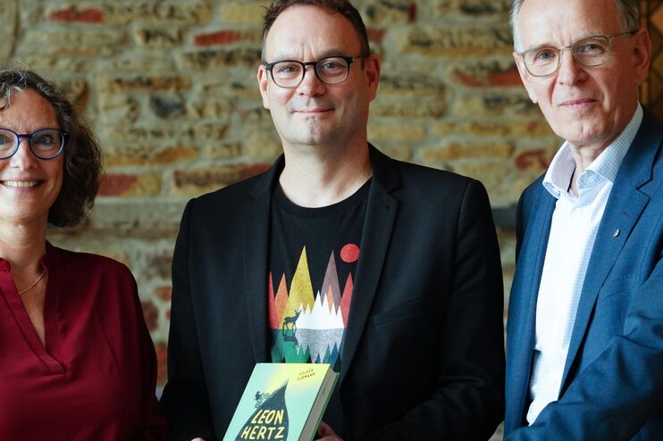 Eine Frau und zwei Männer und ein Buch.