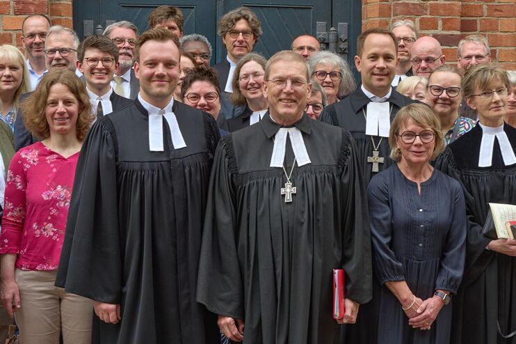 Ein Gruppenfoto mit vielen Menschen in feierlicher Kleidung